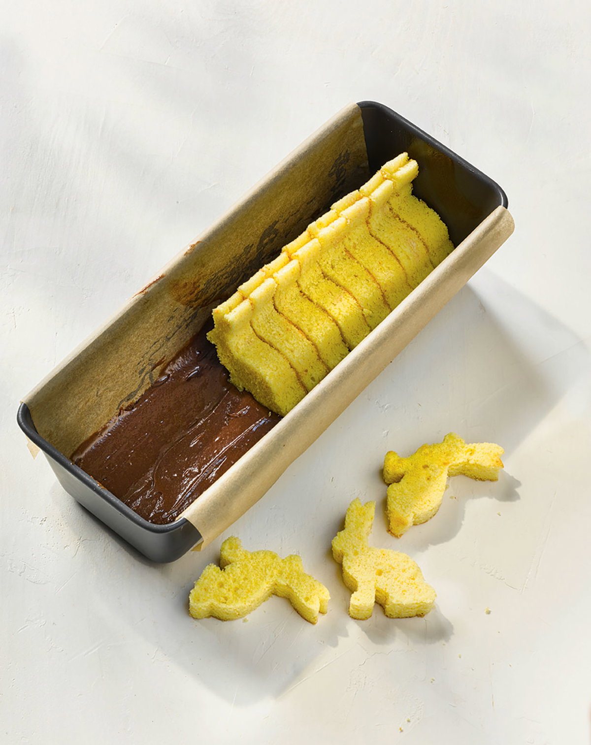 Fyld formen halvt op med chokoladedejen, og læg kaninerne indeni.